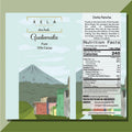 Image of a chocolate bar packaging with a graphic representation of a Guatemalan landscape and a village, alongside the brand name 'Xela' and the percentage of cacao '70% Cacao'.