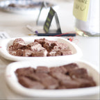Close-up of a chocolate dessert in a white container with a blurred background