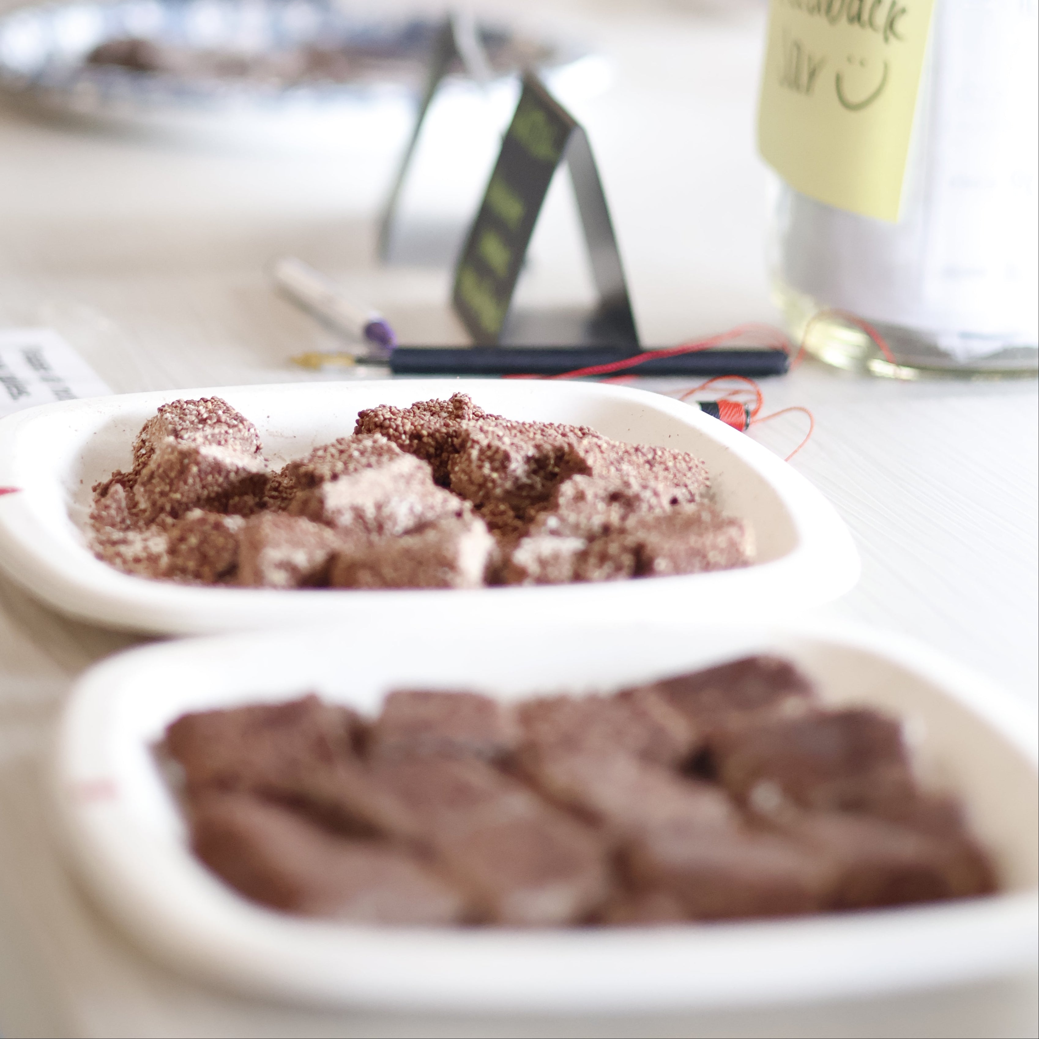 Close-up of a chocolate dessert in a white container with a blurred background